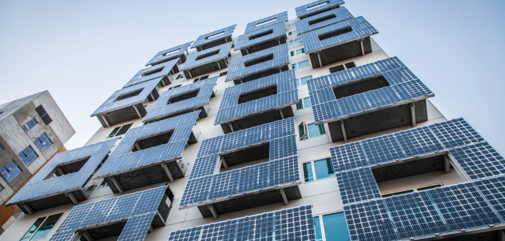 Many solar panels on side of apartment building